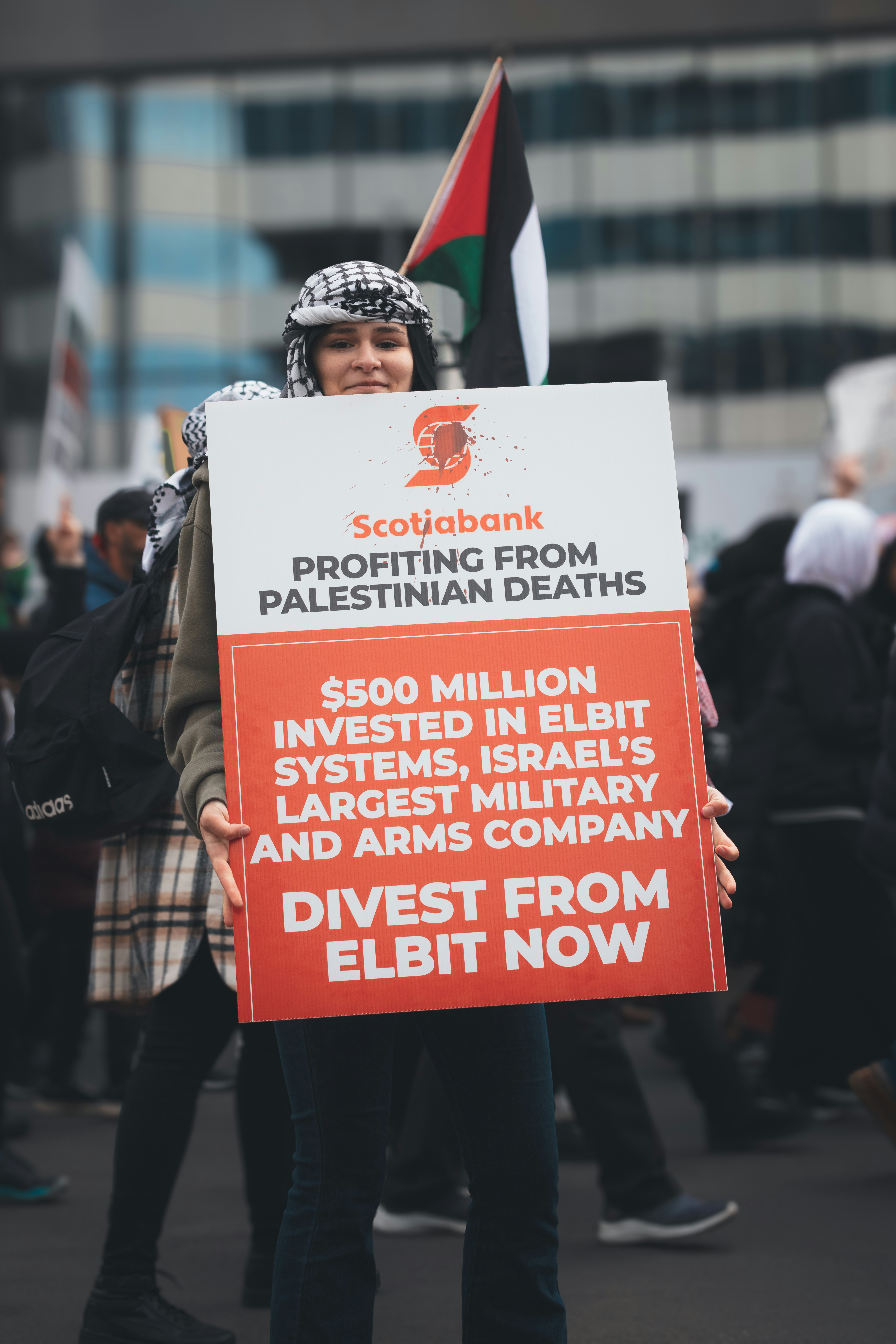 a person holding a sign in a protest